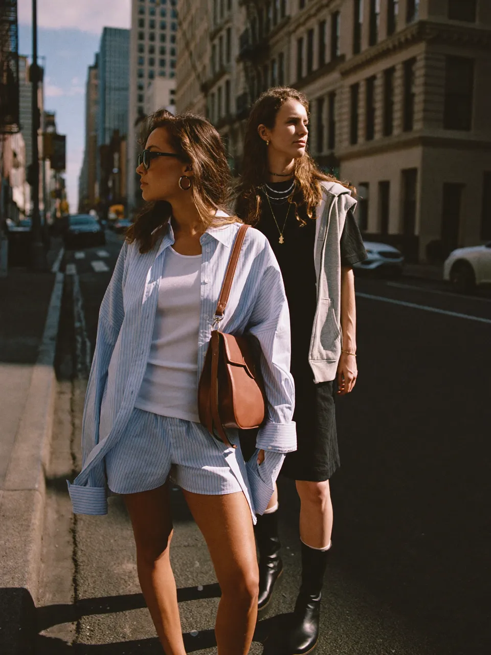 Two adults on a sunlit city street